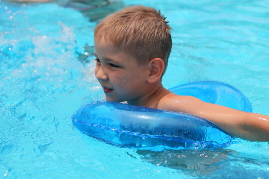 Cute happy little boy swimming and snorking in the swimming pool