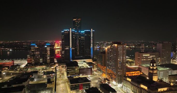 Detroit, Michigan skyline at night with drone video circling.