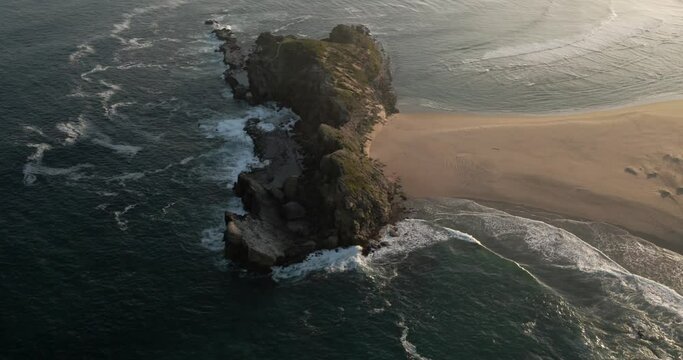 Aerial View South Africa Robberg Nature Reserve Sandy Peninsula with ocean waves crashing on the beach and rocks