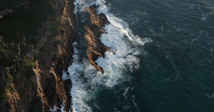 Aerial View Robberg Nature Reserve powerful ocean waves crashing on rocks near the shore