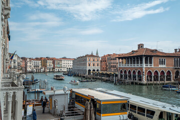Fototapeta na wymiar Grand Canal, gondola, and local transportation with blue sky background in Venice, Italy