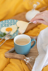 A cup of cappuccino and a chocolate heart. View from above