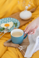 A cup of cappuccino and a chocolate heart. View from above
