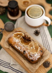 A cup of aromatic tea and a cupcake with citrus fruits