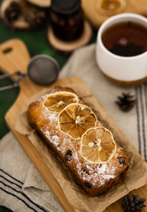 A cup of aromatic tea and a cupcake with citrus fruits