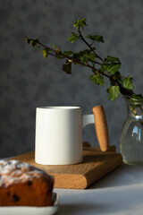 A cup of coffee on the table and a fragrant cupcake nearby