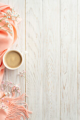 Hello spring concept. Top view vertical photo of cup of fresh coffee gypsophila flowers and pink...