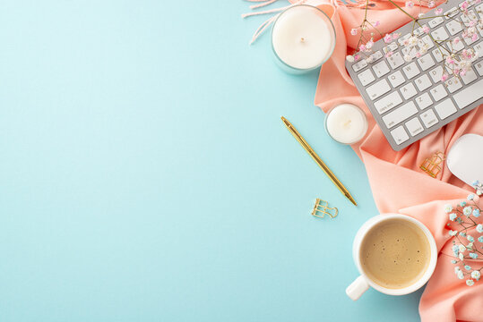 Business concept. Top view photo of keyboard cup of coffee candles golden pen binder clips gypsophila flowers and pink plaid on isolated pastel blue background with empty space