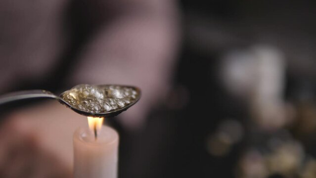Cooking a teaspoon dose of heroin, the concept of hard drugs 4k