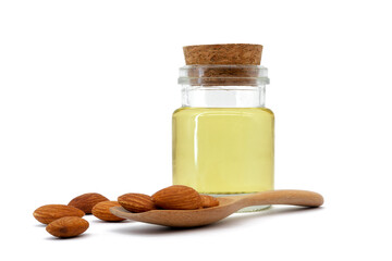 Almond oil in glass bottle and group of almond nuts isolated on white background. Almond oil with almond seeds.