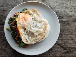 Stir-fried basil on rice with a fried egg is a popular Thai dish that can be found at street food stalls.