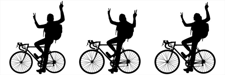 Girl riding a bicycle. Girls for joy raise both hands high, showing the gesture 