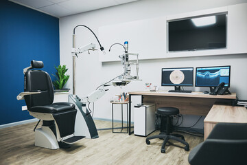 Optometry, empty room and equipment for vision test for eye care in a optical clinic or store. Optic healthcare, ophthalmology and computers, technology or machines in optometrist consultation office - obrazy, fototapety, plakaty