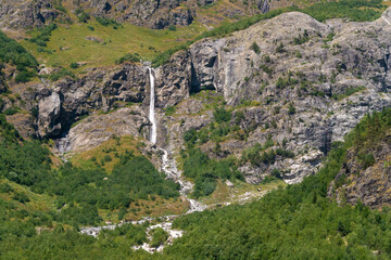 Fototapeta na wymiar Beautiful mountain landscape with Shdugra waterfall, Mazeri, Svaneti, Georgia on a sunny bright summer day