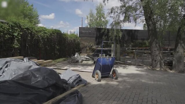 
construction works building workers mess dirty sunny trash cart