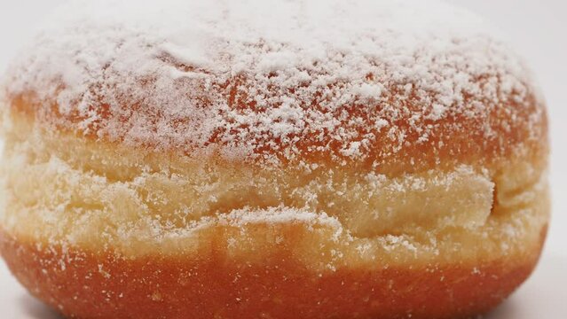 Freshly baked and powdered German donuts. Berlin donut or krapfen isolated on white background.