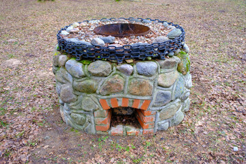 Obraz premium idyllic outdoor barbecue area - built with flat stones campfire place. For public use.