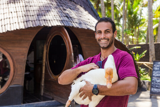 Man holding goose, Bali, Indonesia