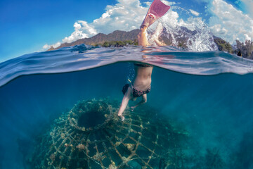 Woman snorkeling underwater,Â Perebutan, Bali, Indonesia