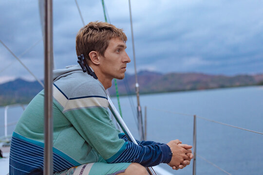 Man on sailboat sailing in sea,&Acirc;&nbsp;Lombok, Indonesia