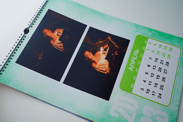 Obraz premium a flip calendar with family photos. teen girl blows out candles on cake