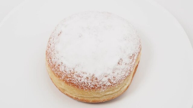 Freshly baked and powdered German donuts. Berlin donut or krapfen isolated on white background.