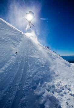 A Skier Hits A Jump And Grabs His Skies While Skiing At Cerro Catedral In Argentina