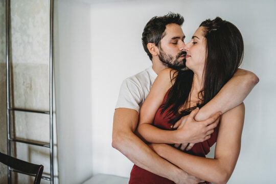 Young happy couple embraced in the morning in the home