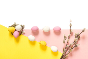 candy Easter eggs on a light white-pink and yellow background. Happy easter. copy space	