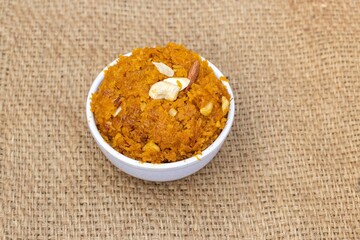 Gajar Ka Halwa or Carrot Halva Garnished with Cashew and Almond Isolate Burlap Fabric with Copy Space