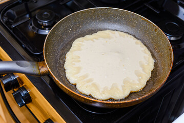 preparing homemade pancakes cooking, in a pan.Cooking pancakes in a pan.Homemade pancakes.Closeup.