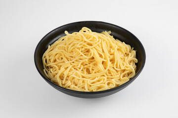 egg noodle in a black bowl isolated on white background