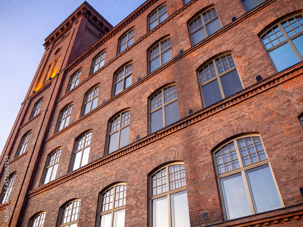 Wall mural Old finnish industrial building made of bricks. This old spinning mill was built in 1890s, it has a tower and large arched windows.