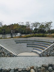 The small arena seating  and stone sidewlk in the park in Taichung, Taiwan