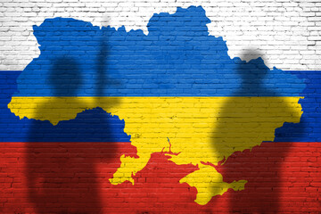 Flag of Ukraine and Russia painted on a brick wall. Relationship between Ukraine and Russia