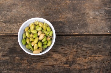 Top View of Raw Garbanzo Bean or Chickpea Pods in Bowl Isolated on Wooden Background with Copy Space, Also Known as Bengal Gram or Egyptian Pea