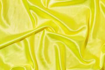 Creative layout with neon yellow satin texture background. 80s or 90s retro fashion aesthetic...