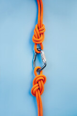Grey carbine with clutch. Equipment for climbing and mountaineering. Safety rope. Knot eight