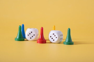 Dice and chips for playing on a yellow background, close-up