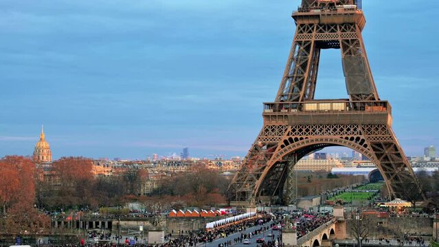 View of the Eiffel Tower in Paris from the Trocadero Square at sunset, France. Jena Bridge with multiple people and cars, cityscape