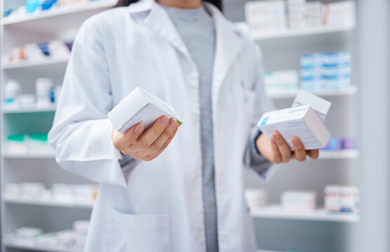 Pharmacist, pills and medicine with hands of woman in store for healthcare, wellness and retail. Closeup of medical products, pharmacy shopping and boxes of supplements, tablets and package stock