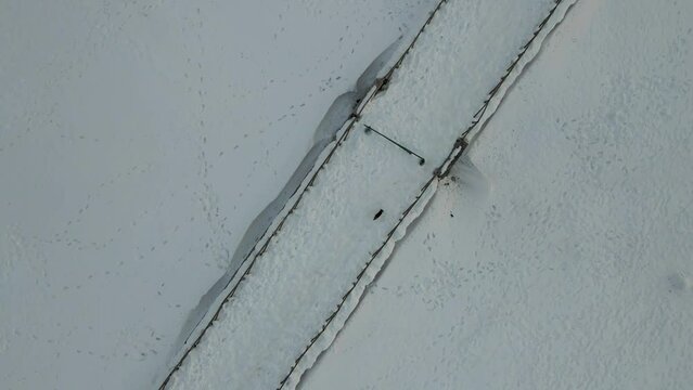 Aerial view of a trekking trail at Verteglia Plateau with snow in wintertime on Mount Terminio, Serino, Avellino, Irpinia, Campania, Italy.