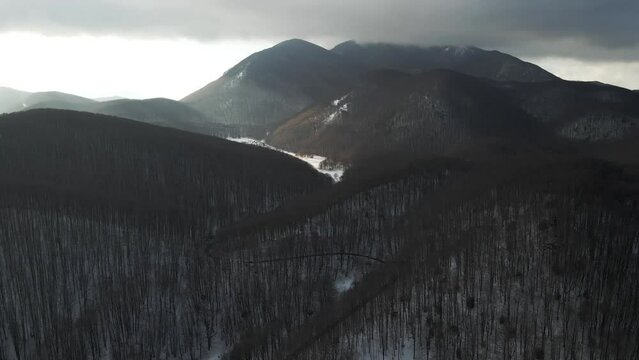 Aerial view of Mount Terminio landscape with snow in wintertime at sunset, Serino, Avellino, Irpinia, Campania, Italy.