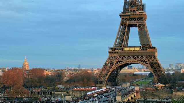 View of the Eiffel Tower in Paris from the Trocadero Square at sunset, France. Jena Bridge with multiple people and cars, cityscape