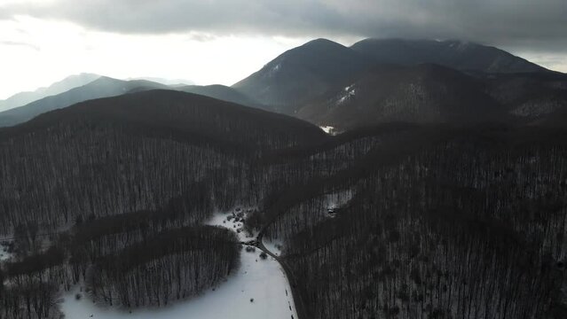 Aerial view of Verteglia Plateau with snow in wintertime at sunset on Mount Terminio, Serino, Avellino, Irpinia, Campania, Italy.