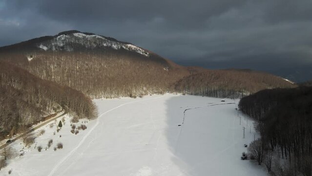 Aerial view of Verteglia Plateau with snow in wintertime at sunset on Mount Terminio, Serino, Avellino, Irpinia, Campania, Italy.
