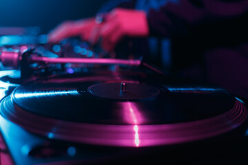 Fototapeta na wymiar Club dj playing music on dance party. Background with disc jockey mixing vinyl records in night club