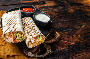 Shawarma, Shaurma chicken roll  with  vegetable salad. Wooden background. Top view. Copy space