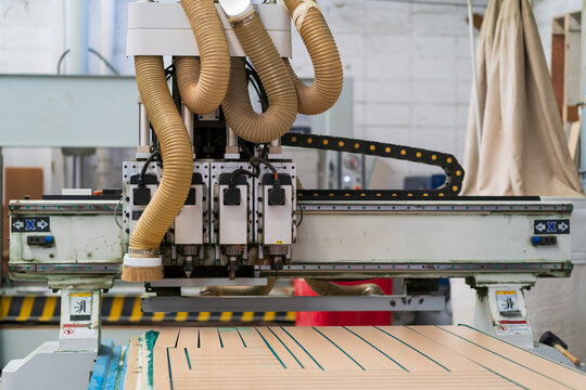 Wood CNC machine at carpentry workshop. Production line of the wooden factory. CNC automatic woodworking machine in manufacturing industry