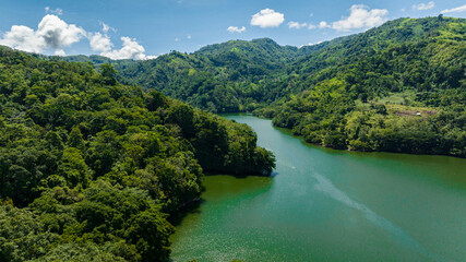 Aerial drone of lake among mountains with tropical forest. Lake Balanan. Negros, Philippines
